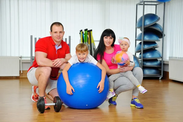 Happy family in fitness club. Happy sporty family