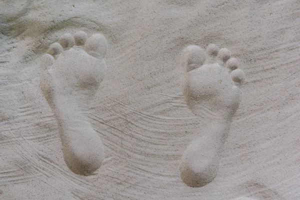 Shaped human footprints in the sand