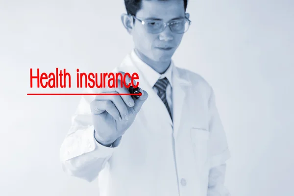 Blurred Doctor writing Health insurance