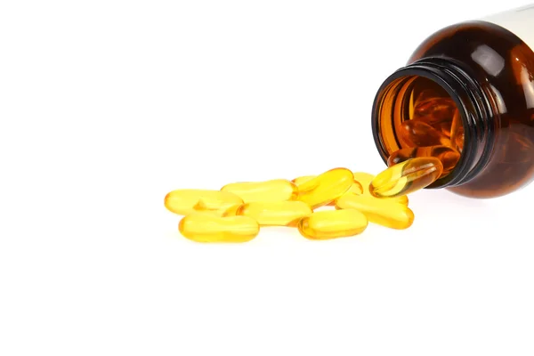 Fish oil capsules with bottle on white background
