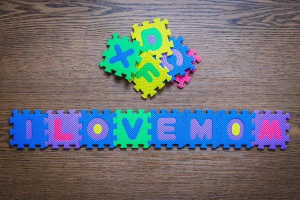 I love mom Plastic ABC text jigsaw puzzle,on wood table from child autism.
