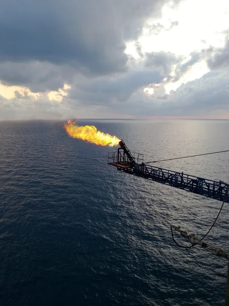 Flare boom nozzle and fire on offshore oil rig