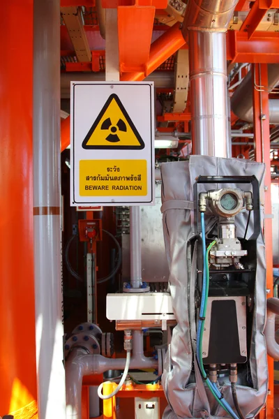 Flow meter, with high radiation sign.