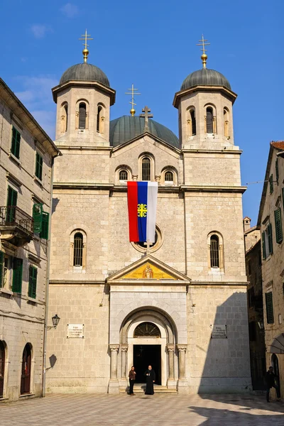 KOTOR/ MONTENEGRO - MARCH 12, 2015: View of Serbian Orthodox church  of St. Nicholas with Serbian flag from St. Luke's Square