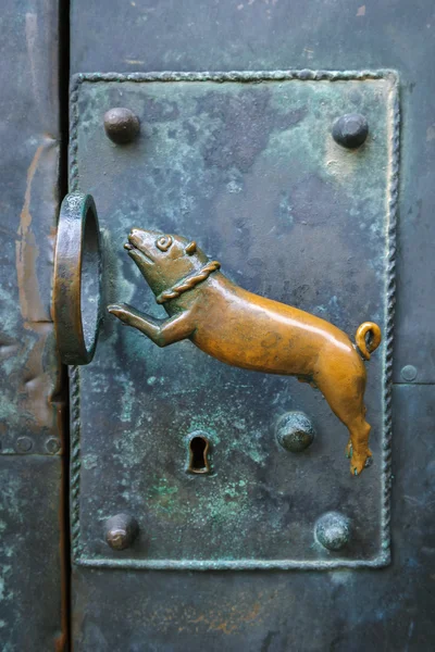 Door handle in the form of a dog jumping through a ring in the castle of Quedlinburg, Germany