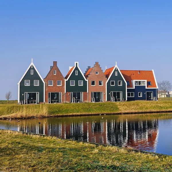 Colored houses of marine  park in Volendam reflected in