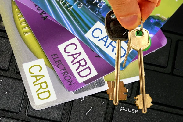 The keys to the house against the background of credit cards