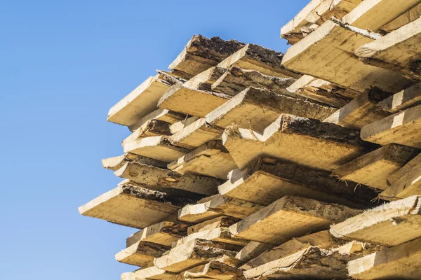 The lumber on the background of blue sky