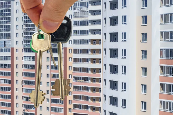 The keys to the apartment on the background of houses