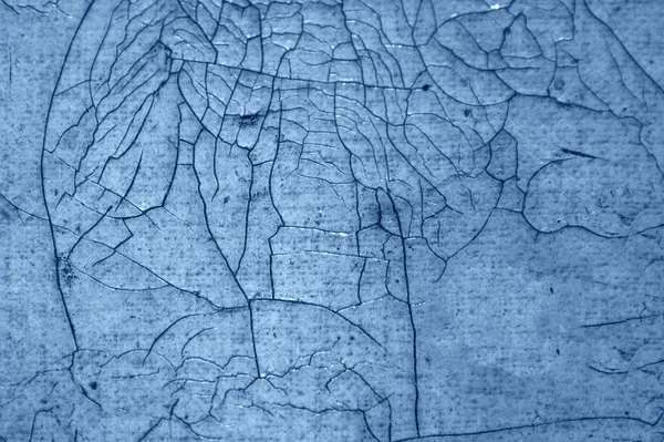 Close-up detail of cracked paint on wall. black and blue