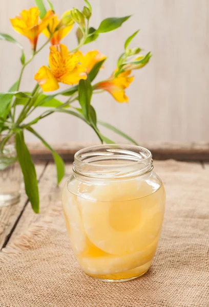 Canned pineapple rings in glass with flowers