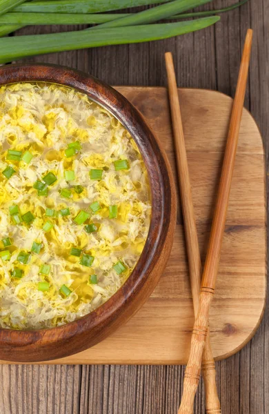 Hot vegetarian egg drop soup with starch noodlein wooden bowl