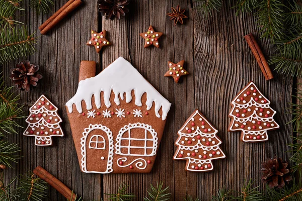 Gingerbread cookies house stars and fur trees in new year composition frame. Homemade traditional christmas dessert recipe.