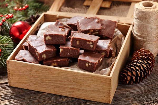Christmas fudge traditional homemade chocolate sweet dessert food in wooden box on vintage table background.