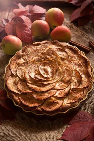 Traditional homemade aplle pie winter holiday celebration sweet baked dessert food with cinnamon and apples on vintage table background. Autumn decor.