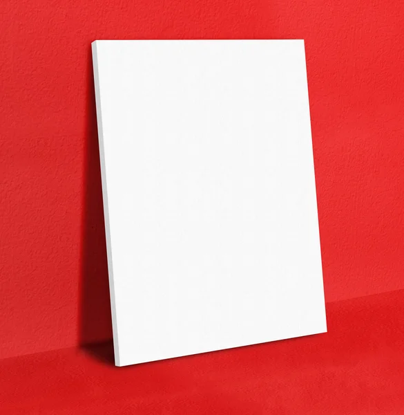 Blank white poster canvas frame leaning at red concrete paint wa