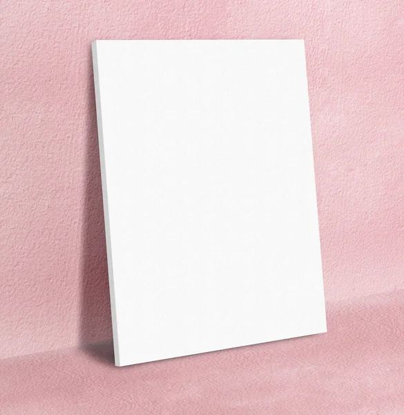 Blank white poster canvas frame leaning at pink concrete paint w