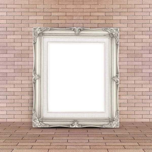 Blank Vintage white picture frame leaning at red brick floor and