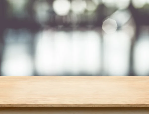 Empty wood table top with office building hall way blur backgrou