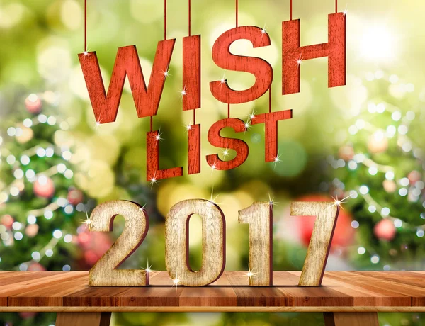 Wish list 2017 number on Brown Wood table top with abstract blur