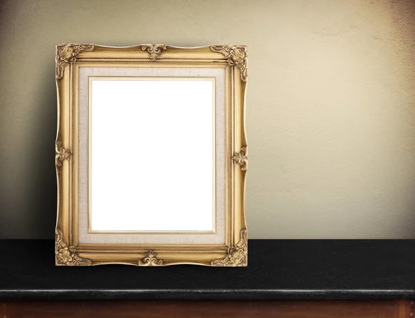 Blank Gold victorian picture frame on black marble table at yell