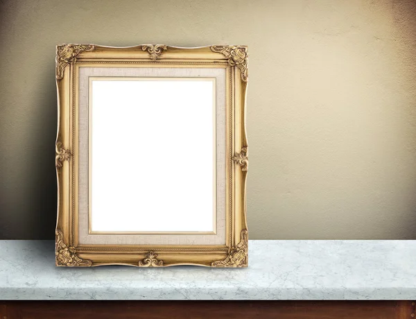 Blank Gold victorian picture frame on marble table at yellow con