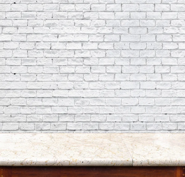 Empty marble table and white brick wall in background. product d