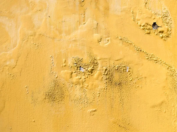 Yellow erode painted concrete wall,grunge rough texture backgrou