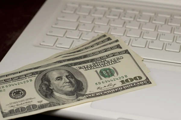 Money on a keyboard of a laptop