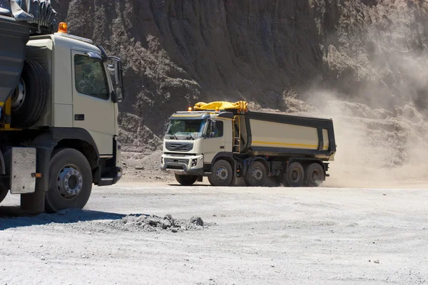 Truck and bulldozer work in the quarry