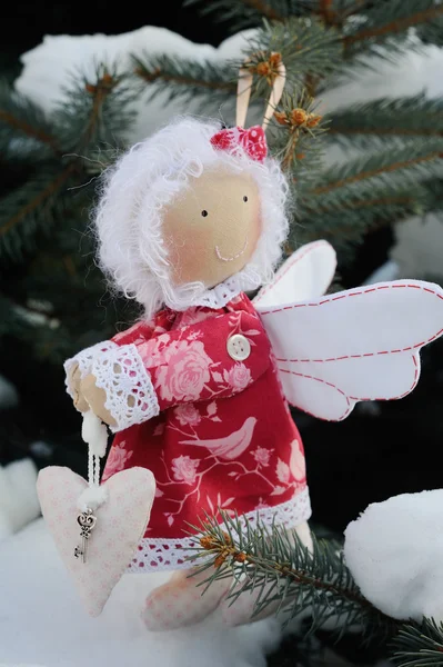 Christmas tree toy angel with heart in hands. Christmas Toy ange