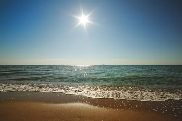 Sun on the background of sea and sand