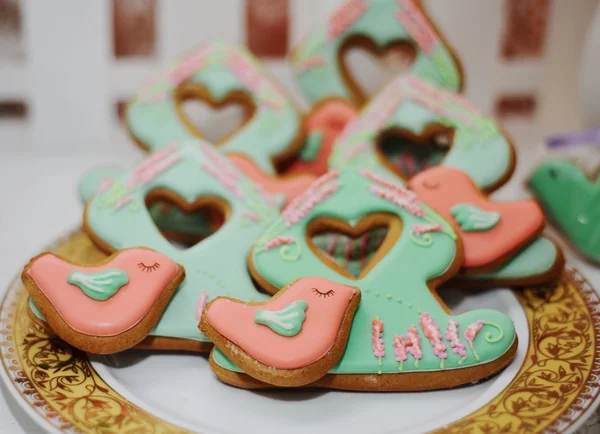 Cookies in the shape of birds pink and green trees