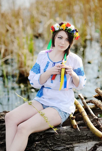 Ukrainian girl in a dress and a wreath of flowers on her head si