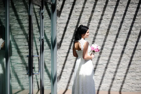 Beautiful bride with a wedding bouquet of orchids