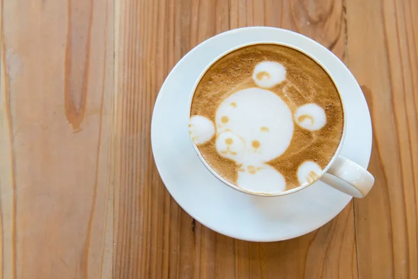 Hot milk art coffee on wooden table