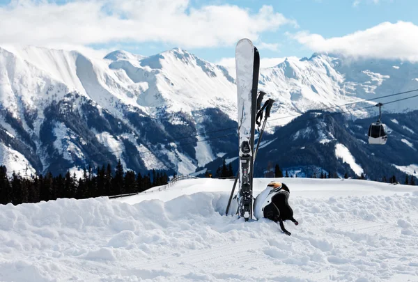 Winter landscape with skis, helmet and goggles