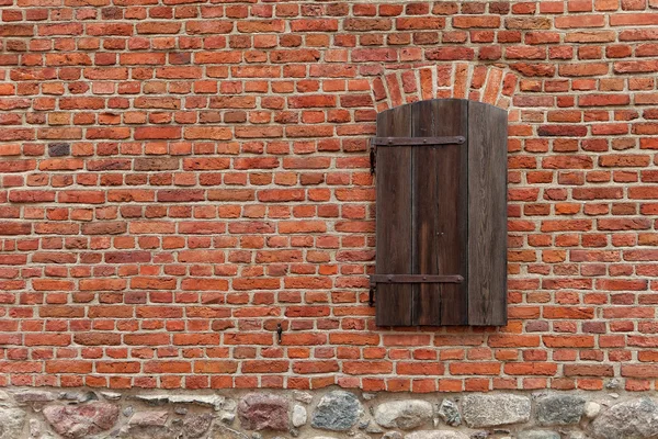 Red brick wall with window
