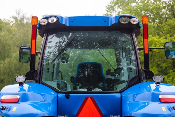 Cabin of the new blue tractor. Rear view. Close up.