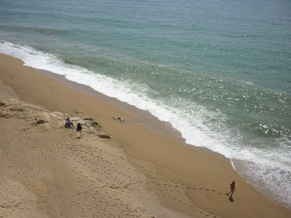 Footprints in the sand and people in spain