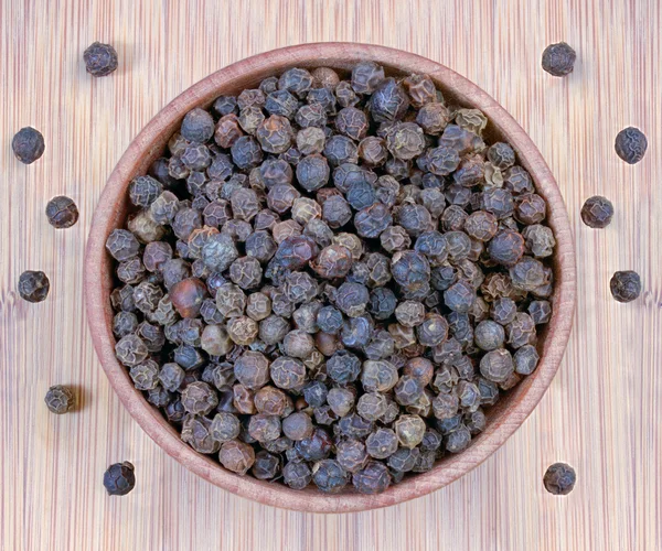 Black pepper in a wooden bowl