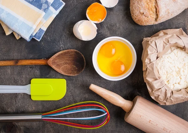 Baking kitchen utensils on vintage planked wood table from above