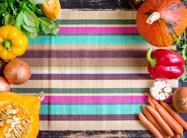 Fresh vegetables on a colorful striped kitchen towel. Autumn bac