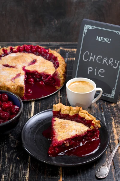 Cherry pie, cup of coffee and menu chalkboard