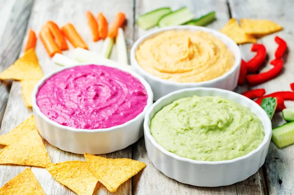 Multicolored vegetables beans hummus with vegetables and chips
