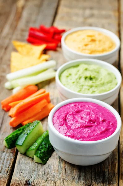 Multicolored vegetables beans hummus with vegetables and chips