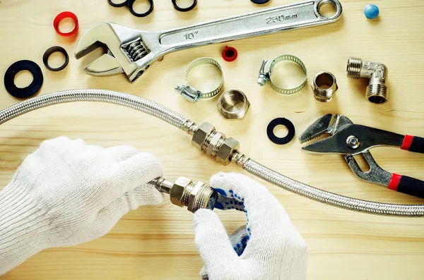 Plumber at work with tools plumbing