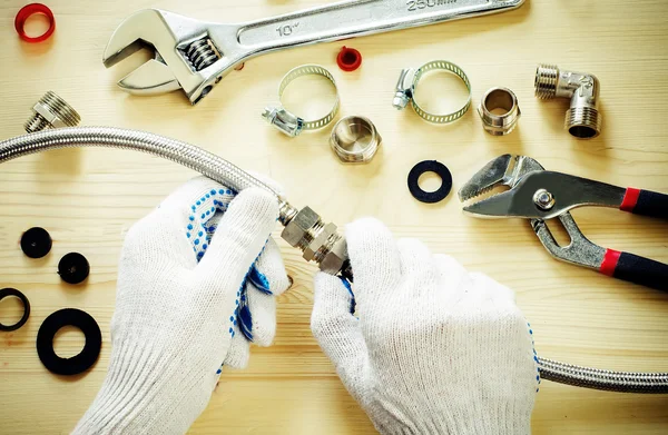 Plumber at work with tools plumbing