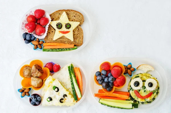 School lunch boxes for kids with food in the form of funny faces