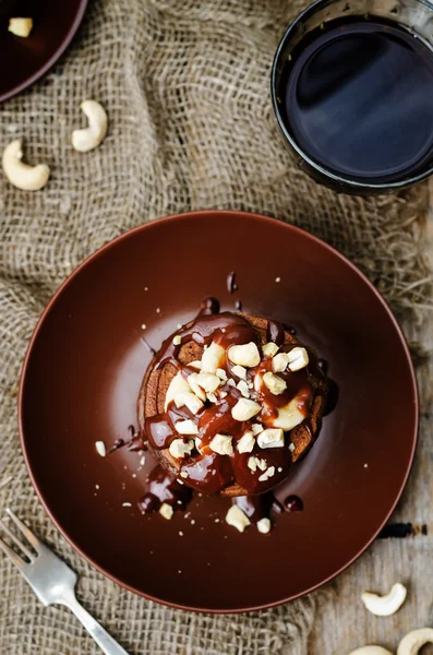 Chocolate pancake with bananas, nuts and chocolate sauce